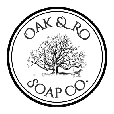 Oak & Ro Soap Co. logo is a black circle outlining an image of our Jack Russell/Yorkie mixed pup, under a giant oak tree. The words "Oak & Ro" are curved above the tree, and "Soap Co." rests on the bottom curve of the circle.